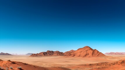 Fototapeta premium Breathtaking desert landscape featuring vibrant red sand dunes stretched out under a vast cloudless azure sky This serene minimalist scene captures the natural beauty and tranquility of an arid