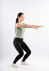 Full body image of young Asian girl wearing sports outfit and posing on white background