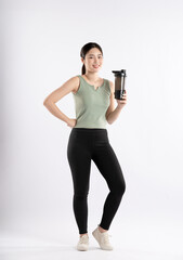 Full body image of young Asian girl wearing sports outfit and posing on white background