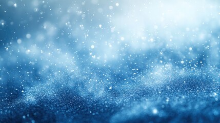 Abstract blue background with bokeh lights and glitter.