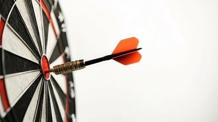 A dart with an orange fletching is in the bullseye of a dartboard.