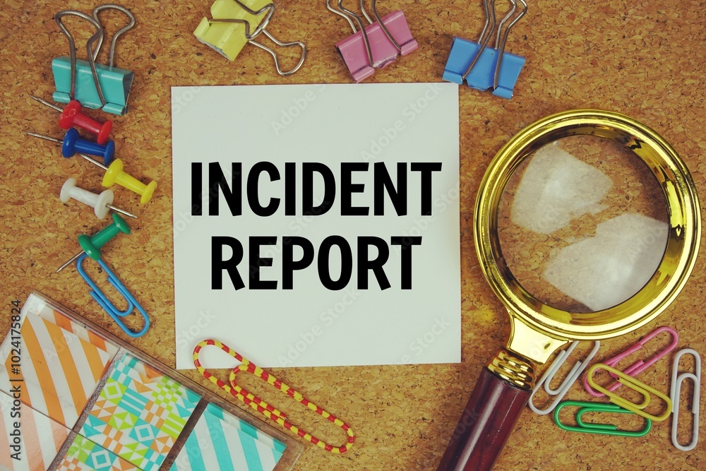 Wall mural incident report text on paper card with magnifying glass and stationery on cork board background