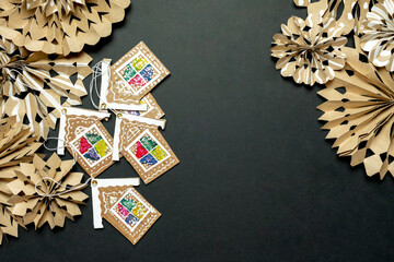 Christmas background in eco style. Black background with Christmas decorations made of kraft paper...