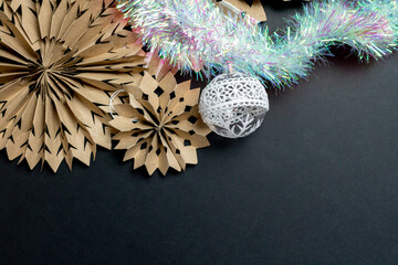 Christmas background in eco style. Black background with Christmas decorations made of kraft paper...