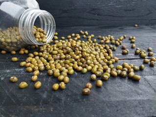 Fresh mung beans on the black wooden table 