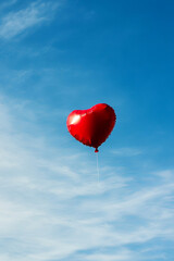 Fototapeta premium Heart-shaped balloon floating in the air