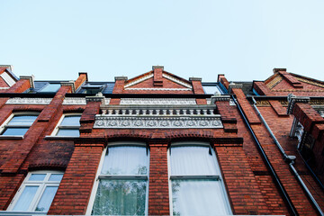 Victorian architecture facade reaching towards a blue sky in london england