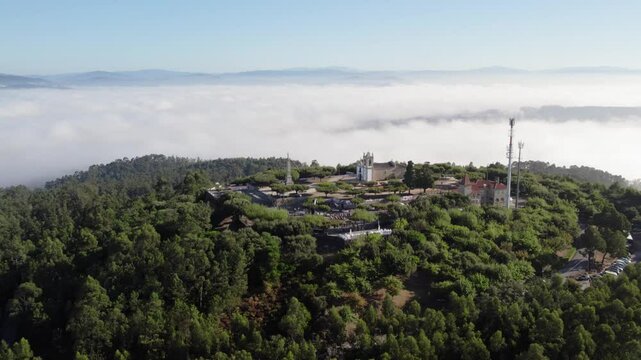 Monte Franqueira in Barcelos rises through morning fog, surrounded by dense forests and hills