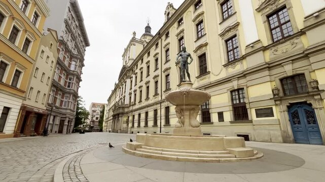4K cinematic of Wroclaw University building and The Swordsman Fountain early morning with no people