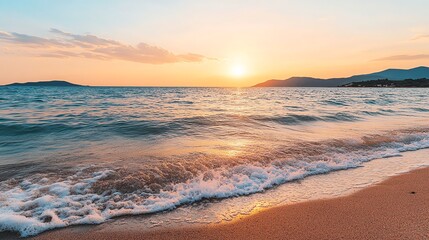 Serene beach scene at sunset with a distant mountain range and tranquil waves.