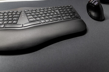 Ergonomic keyboard and ergonomic mouse as ergonomic home office equipment for freelance work and healthy workplace for notebook and clean desktop for efficient work from home for video editing graphic