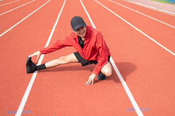 Young cool Asian men in sportswear stretching in sports fields in various poses in bright sunny morning to maintain health and healthy lifestyle. morning exercise healthy and active living concept