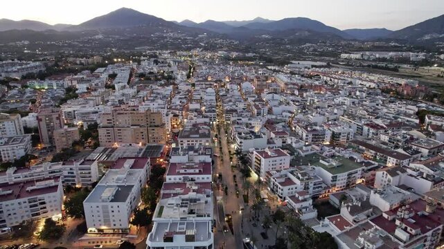 Urban landscape seen from above at twilight with city structures and beautiful lighting below. San Pedro Alcantara, Marbella, Malaga, Andalucia, Spain