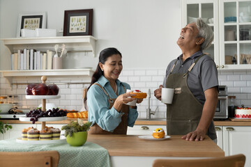 Happy Senior Couple Enjoying Coffee in Kitchen
