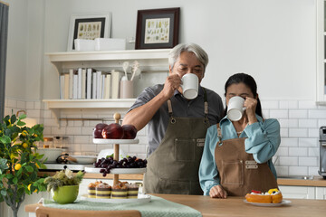 Happy Senior Couple Enjoying Coffee in Kitchen