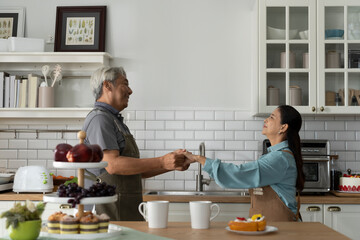 Asian Senior Couple Dancing Joyfully in Kitchen