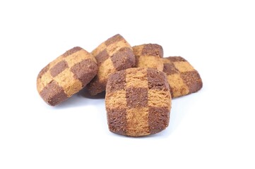 Shortbread and chocolate cookies with checkered pattern on the surface. White background.