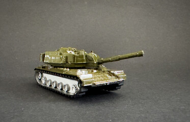 Green Plastic Tank Toy Side View Isolated on White Background.