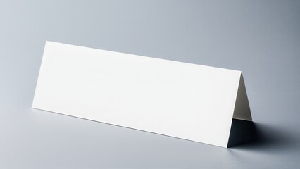 Minimalist bookmark mockup showing a classic, rectangular bookmark in a neutral setting. Great for use in digital or print media presentations, focusing solely on the bookmark design