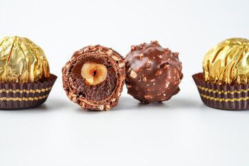 chocolate and hazelnut confectionery balls. chocolate sweet made. Chocolate candies in a gold wrapper