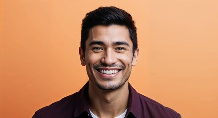 Obraz premium Young Latino man with narrow face grinning warm orange background