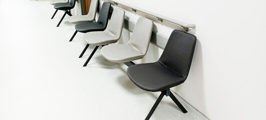 hospital corridor narrow corridor bright floor rooms and gray and orange armchairs wooden blocks