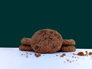 Close-up shot A stack of four chocolate chip cookies. Perfect for wallpaper, background, or wall Frame. It is Ideal for using advertisements or food bloggers