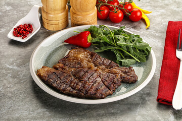 Grilled chuck roll steak with arugula