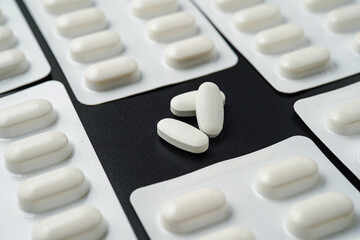 Antibiotic pills Medicine tablet capsules in blister pack on a black background