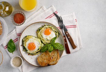 fried egg in zucchini noodle nest with sesame on the plate and napkin, healthy breakfast, top view, copy space