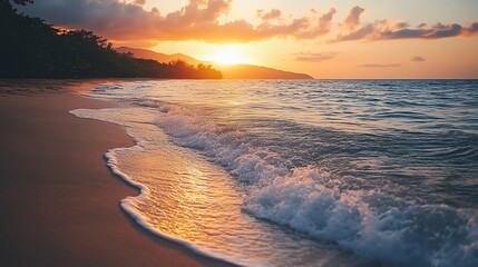 A beautiful golden sunset over the ocean with soft waves lapping onto a sandy beach.