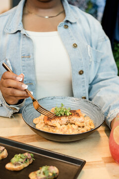 Woman sitting at a table with food