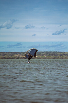 Wing foil rider riding in the lake.