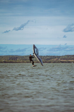 Wing foil rider riding in the lake.