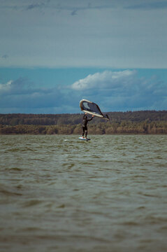 Wing foil rider riding in the lake.