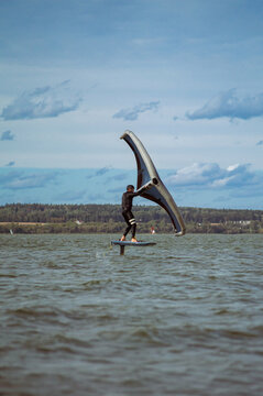 Wing foil rider riding in the lake.