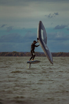 Wing foil rider riding in the lake.