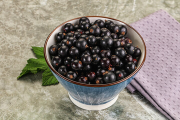 Ripe black currant in the bowl