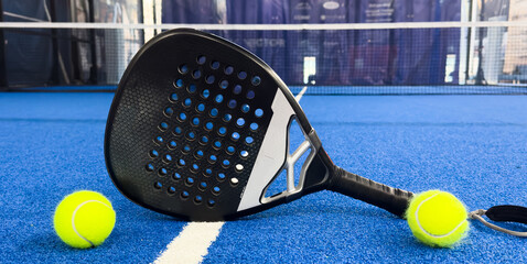 Paddle racket with a ball ready to play the fastest growing sport in recent years worldwide. Padel...