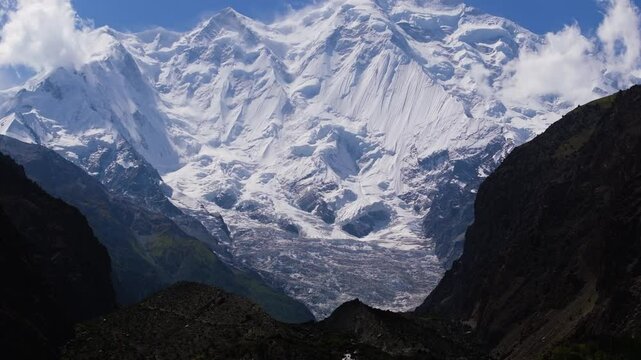 Pan Up Reveals Rakaposhi Mountain Peak - Snow Covered Summit in Rugged Karakoram Range