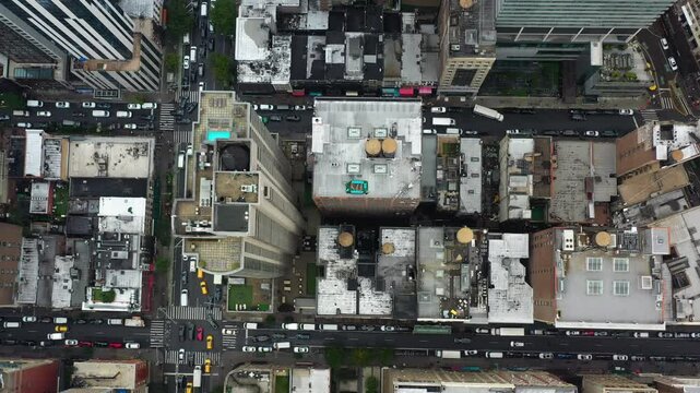 Top down drone shot above buildings and street in Manhattan, in cloudy New York