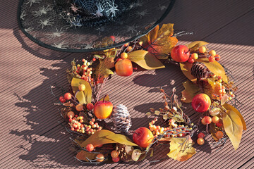 Autumn wreath with leaves and apples and witch cap. Halloween and fall holiday, seasons. Background for design. 