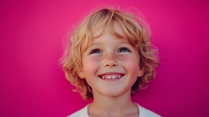11. A child with a mischievous grin, eyes sparkling with playful intent, against a bright pink background.