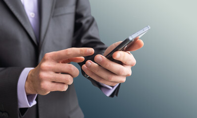 Businessman in the suit is using smartphone
