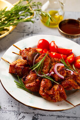Pork kebab with barbecue sauce and tomatoes vertical photo