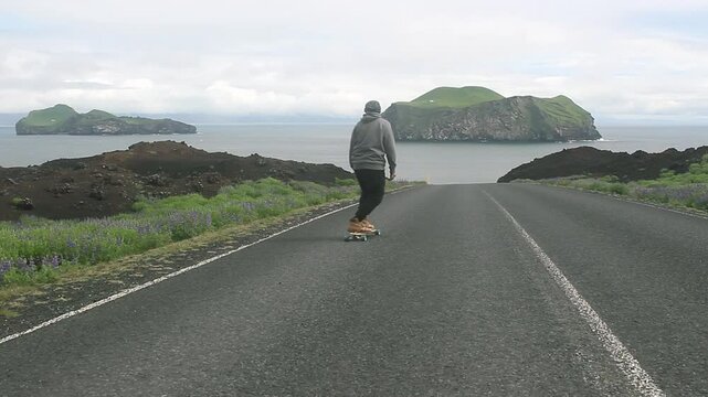 Riding a longboard down road in a beautiful place. Filmed in the Westman Islands, Iceland.