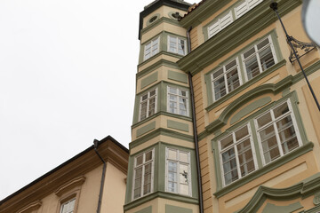There is a prominent building that features a clock prominently displayed on its exterior side, making it easy to tell the time