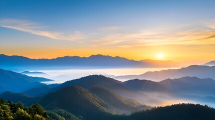 Majestic mountain range with towering peaks and ridges enveloped in a misty golden hour glow creating a serene and atmospheric landscape