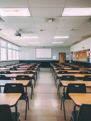 Spacious classroom with rows of desks and chairs, ready for students, in a clean and well-lit learning environment.