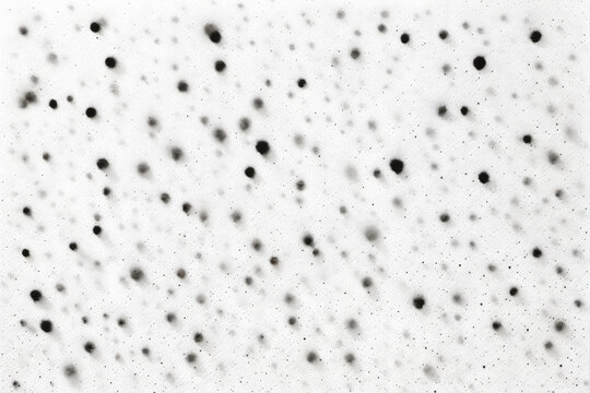 Abstract pattern of scattered black dots on white background. Varying sizes and intensities create depth and texture. Constellation-like, minimalist aesthetic with chaotic yet balanced composition.
